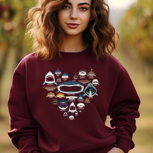 May include: A maroon sweatshirt with a heart-shaped design featuring various shark species. The design includes the names of each shark species.