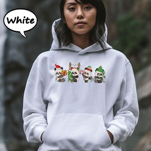 May include: White hoodie featuring a design of four pandas wearing Christmas hats and holding gifts. The text "White" is in a speech bubble above the image.