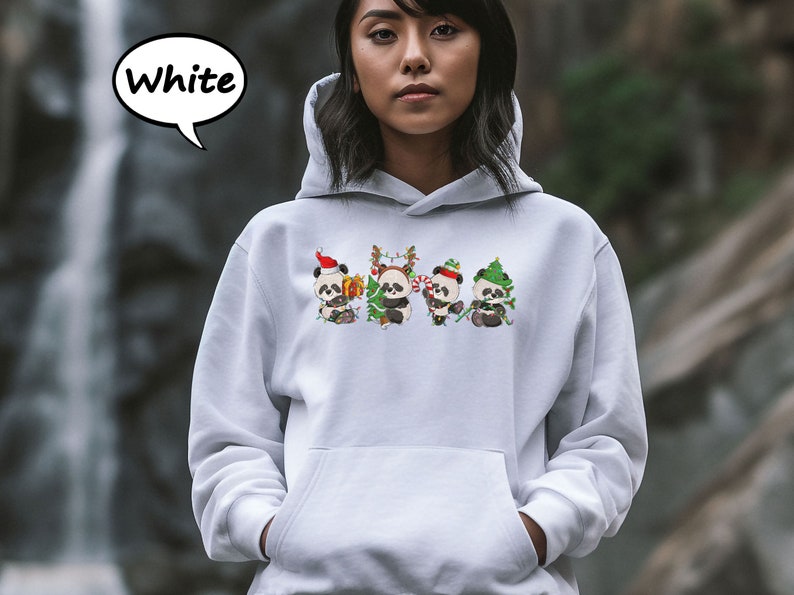 May include: White hoodie featuring a design of four pandas wearing Christmas hats and holding gifts. The text "White" is in a speech bubble above the image.
