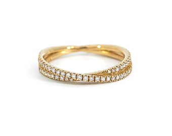 May include: A gold band ring with a double row of small diamonds.