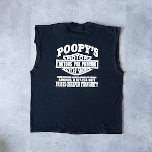 May include: Black sleeveless t-shirt with a white graphic of a motorcycle shop called "Poopy's Motor Tattoos Pub Piercing Cycle Shop". The text below the graphic reads "Unauthorized Harley-Davidson Dealer Savanna, IL 877-273-SHIT Prices Cheaper Than Shit!!"
