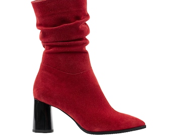 May include: Red suede ankle boots with a block heel and a pointed toe.