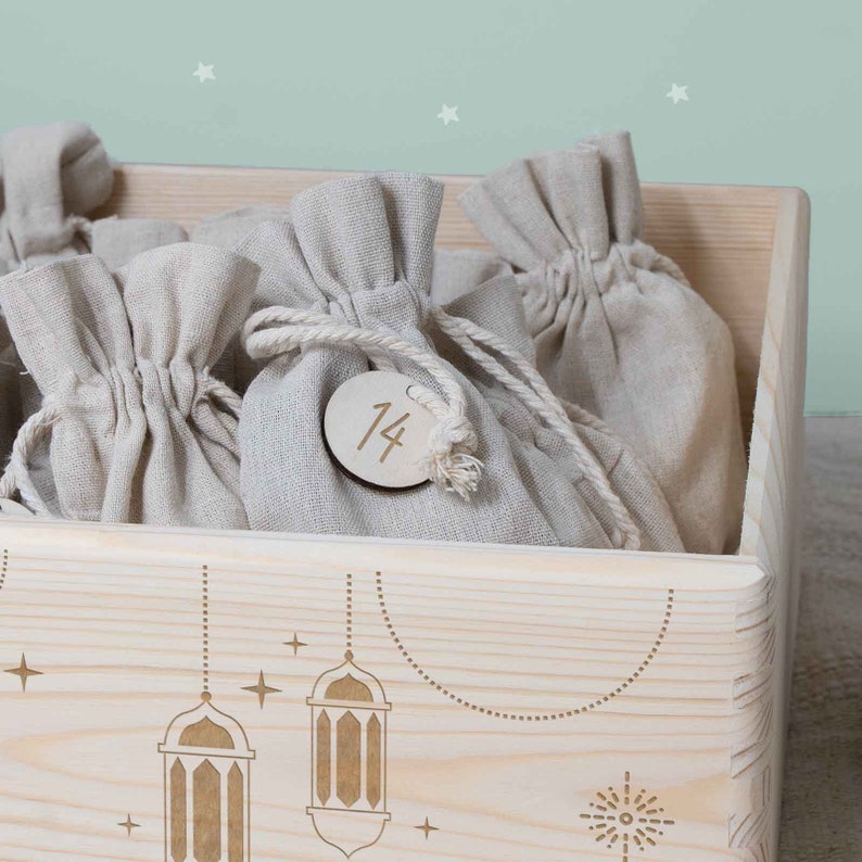 May include: A wooden box with a number 14 on a small tag. The box is filled with small burlap bags. The box is decorated with a design of lanterns and stars.