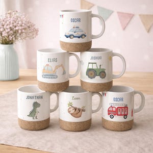 May include: White ceramic mugs with cork bases, each featuring a different design and name: Oscar, Elias, Joshua, Jonathan, Leon, and Oscar. Designs include a police car, excavator, tractor, dinosaur, sloth, and fire truck.