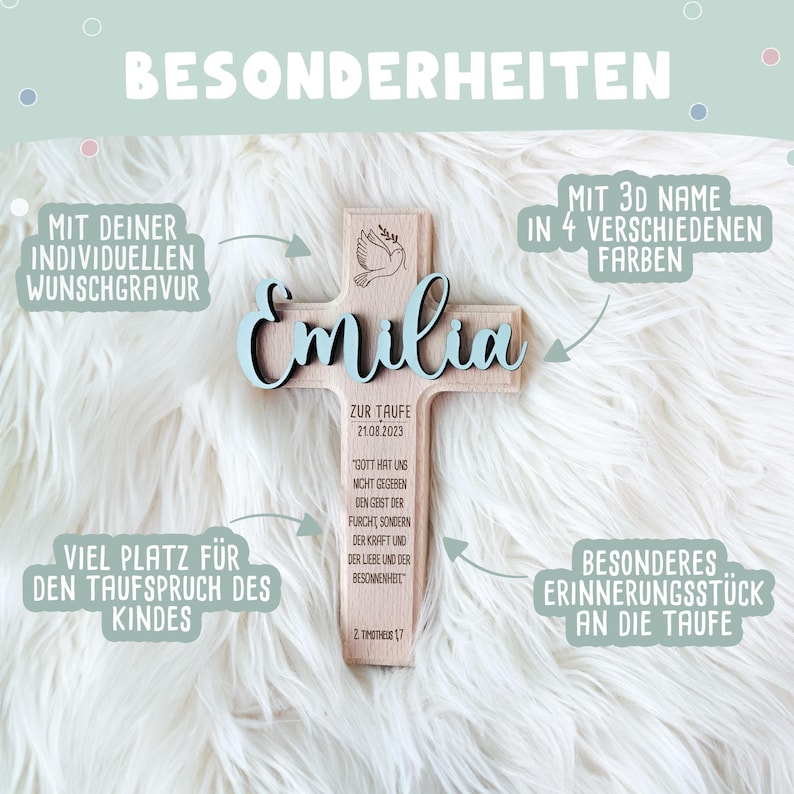 May include: A wooden cross with a dove and the name "Emilia" in blue lettering. The cross is decorated with a quote about faith and the date "21.08.2023". It is a personalized baptism gift.