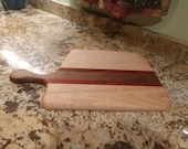 Free form bread board made from Maple, Walnut, and Padauk