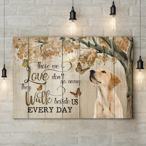 May include: A wooden sign with a quote about love and loss. The quote reads "Those we love don't go away, they walk beside us every day". The sign features a yellow Labrador Retriever looking up at a tree with butterflies.