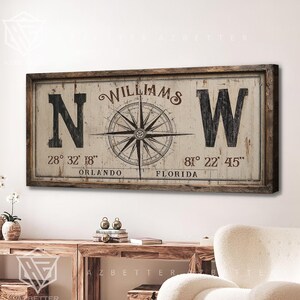 May include: A rectangular wooden sign with a distressed finish. The sign features the name "Williams" above a compass rose design. Large "N" and "W" letters flank the compass, with coordinates and "Orlando, Florida" text below.