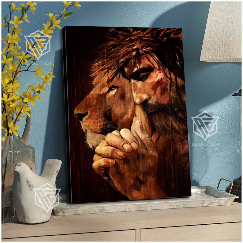 May include: A painting of Jesus Christ with a crown of thorns, depicted as a lion with a human face. The lion's head is turned to the side, and Jesus's hands are clasped in prayer. The painting is on a wooden background.
