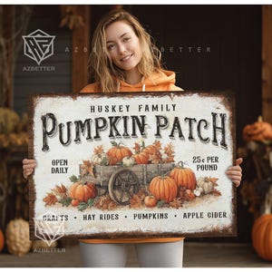May include: A vintage-style sign advertising a pumpkin patch, with the words "Huskey Family Pumpkin Patch" prominently displayed. The sign depicts a wagon laden with pumpkins and autumnal foliage. It also mentions "Open Daily" and "25p per pound."