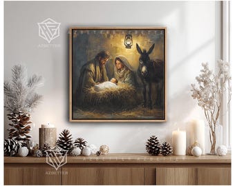 May include: A framed artwork depicts the Nativity scene with Mary, Joseph, and baby Jesus in a manger, illuminated by a lantern. A donkey stands nearby. The artwork is in a wooden frame and is displayed on a wooden surface with decorative candles and pinecones. The text "AZBETTER" is visible.