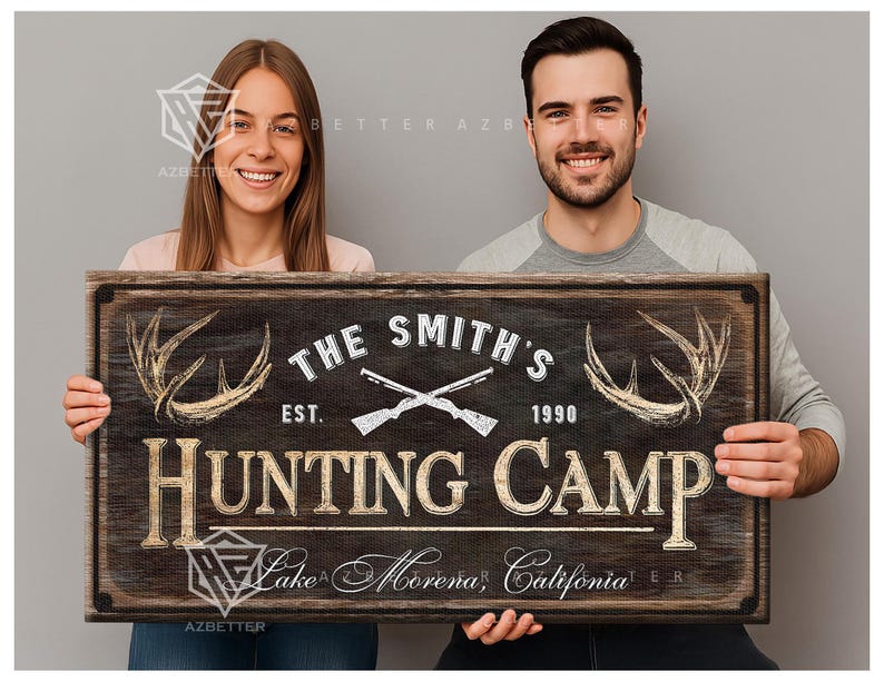 May include: A rustic wooden sign with the text "THE SMITH'S HUNTING CAMP" featuring crossed rifles, antlers, and the year 1990. The sign also includes the location "Lake Morena, California".
