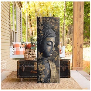 May include: A vertical canvas print featuring a serene Buddha image. The artwork showcases a dark gray Buddha with gold accents, including floral patterns. The Buddha's face is in profile, with closed eyes, conveying a sense of peace. The background is a blend of dark and gold tones.