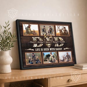 May include: A framed artwork with family photos and a hunting theme. The word "DAD" is in camouflage, with names Oliver, Amelya, James, Henry, and Scarlett. The text "LIFE IS DEER WITH DADDY" is displayed on a dark wooden background.