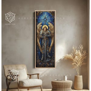 May include: A framed stained-glass artwork depicting an angel with a sword. The angel has golden wings and a halo, set against a blue and gold background. The artwork is displayed in a room with neutral-toned walls and furniture.