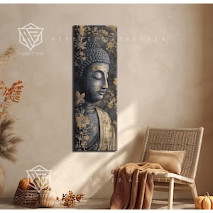 May include: A vertical canvas print of a serene Buddha statue with a dark gray face and gold accents. The artwork features a floral background with gold leaves and flowers. The print is displayed in a neutral-toned room with a wicker chair and decorative items.