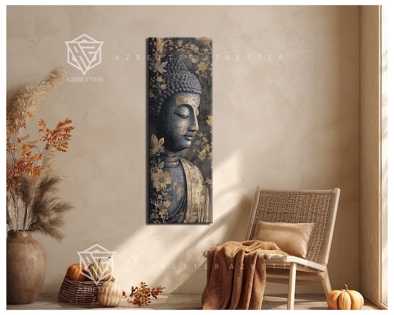 May include: A vertical canvas print of a serene Buddha statue with a dark gray face and gold accents. The artwork features a floral background with gold leaves and flowers. The print is displayed in a neutral-toned room with a wicker chair and decorative items.
