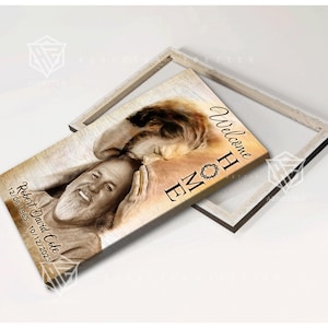 May include: A framed canvas print with a sepia toned image of a man with a crown of thorns. The text "Welcome Home" is printed on the canvas. The man's name and dates are printed below the image.