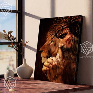 May include: A painting of a lion and a man with a crown of thorns. The lion is on the left side of the painting and the man is on the right. The lion is looking to the right and the man is looking down. The lion's mane is brown and the man's hair is brown. The background is a dark brown color.