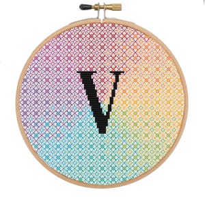 May include: A rainbow-colored embroidery hoop with a black letter V in the center.