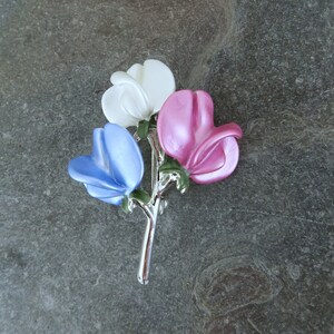 Sweet pea brooch jewellery gift with blue, white and pink flowers, by ATLondonJewels on a slate background.