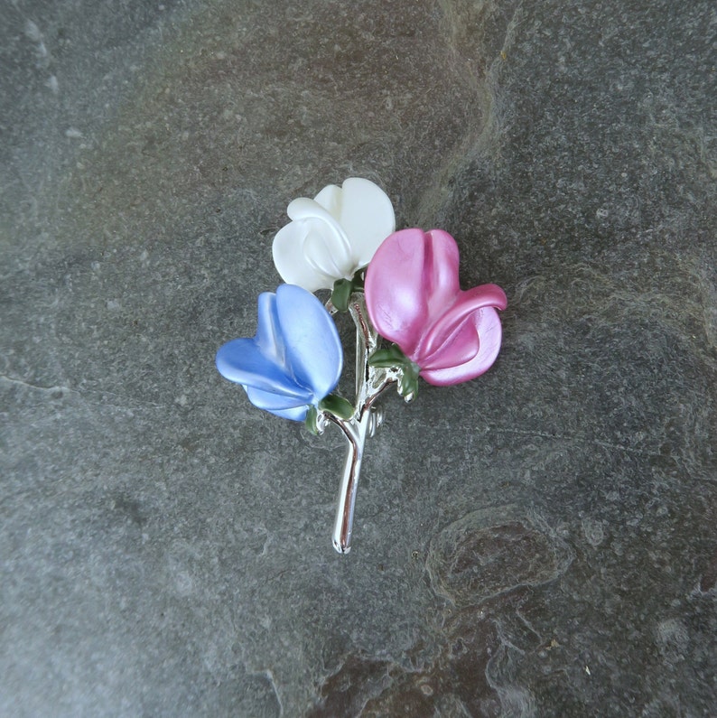 Sweet pea brooch jewellery gift with blue, white and pink flowers, by ATLondonJewels on a slate background.