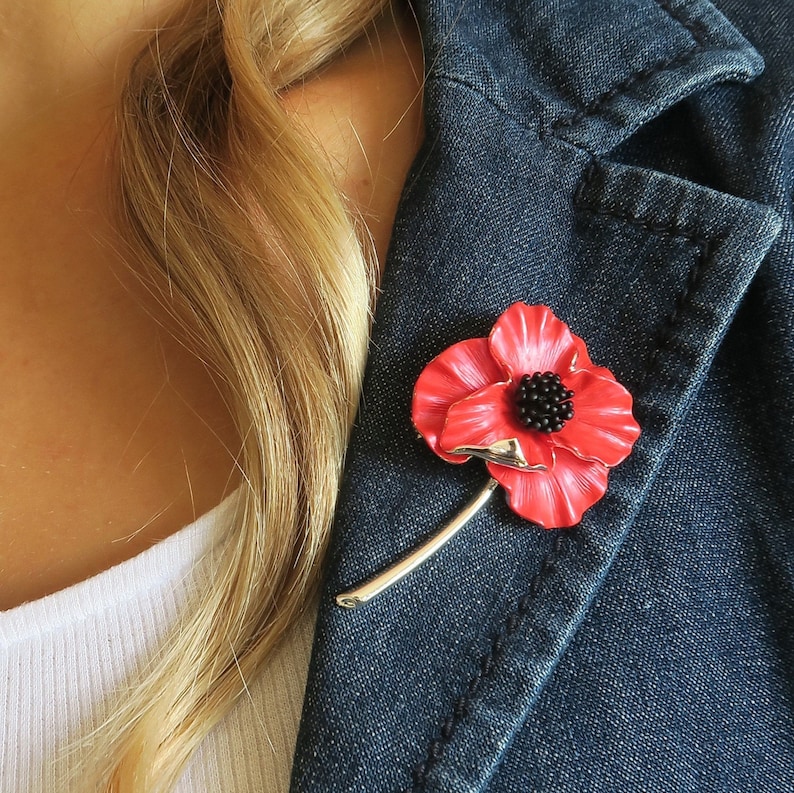 Poppy on stem red flower brooch remembrance gift by ATLondonJewels on a blue jacket lapel.