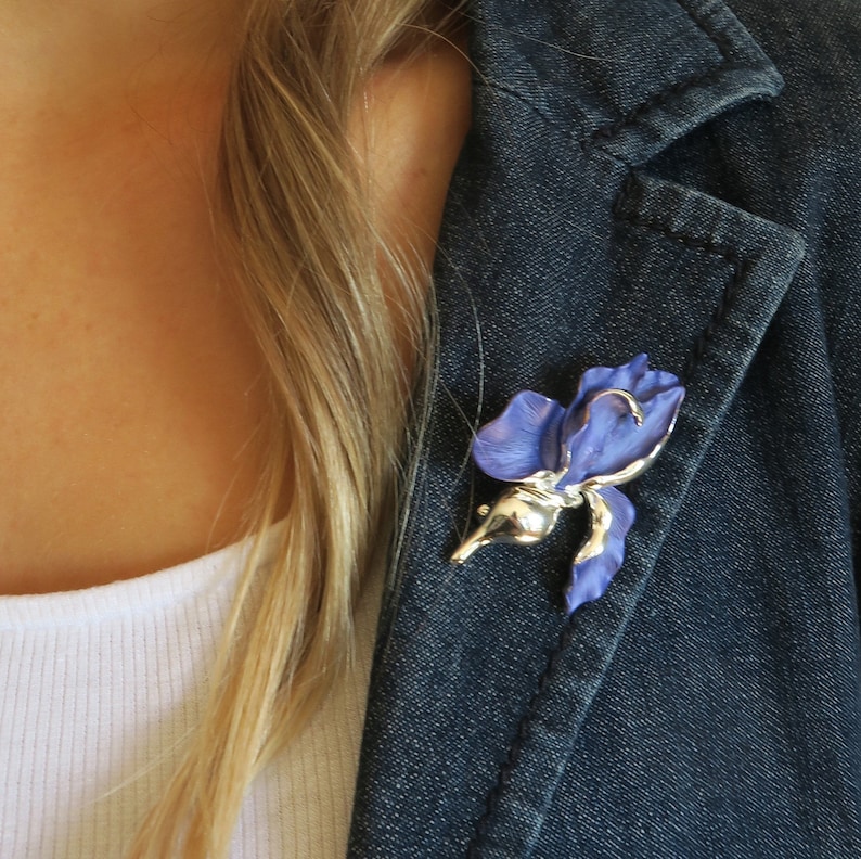 Iris blue flower brooch by ATLondonJewels, pictured on a blue jacket lapel.