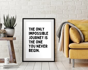 May include: Black and white inspirational quote print in a black frame. The quote reads "The only impossible journey is the one you never begin."