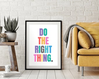 May include: A framed print with the text "DO THE RIGHT THING." in colorful letters on a white background. The frame is black and the print is hanging on a white brick wall.