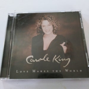 May include: A CD case with a photo of Carole King on the front. The title of the album is "Love Makes the World".