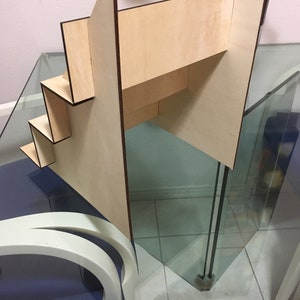 May include: A wooden tiered display stand with four shelves. The stand is made of light wood with a natural finish. The shelves are rectangular and have a slight lip to prevent items from falling off. The stand is ideal for displaying small items, such as jewellery, cosmetics, or crafts.