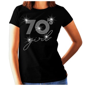 May include: Black t-shirt with a rhinestone design that says "70's girl".