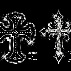 May include: Two rhinestone cross designs. The cross on the left is 20 cm by 23 cm. The cross on the right is 15 cm by 21 cm.