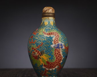 May include: A blue and gold cloisonné bottle with a dragon design. The bottle is decorated with red, green, and white enamel.