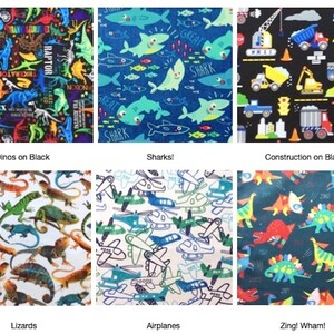 May include: A collection of six fabric swatches featuring various patterns: colorful dinosaurs on black, blue sharks, construction vehicles on black, realistic lizards on white, blue and green airplanes on white, and cartoon dinosaurs on dark blue.
