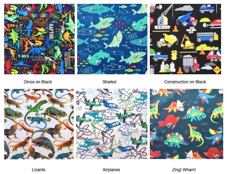 May include: A collection of six fabric swatches featuring various patterns: colorful dinosaurs on black, blue sharks, construction vehicles on black, realistic lizards on white, blue and green airplanes on white, and cartoon dinosaurs on dark blue.