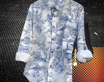 May include: A white long-sleeved button-down shirt with a blue and white floral pattern. The shirt has a traditional collar and a button-up front.