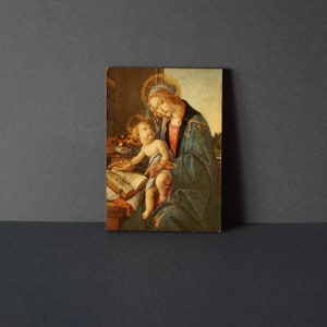 Small sacred icon. Glossy painting on wood, icon Madonna of the Book by Botticelli in Florentine style.