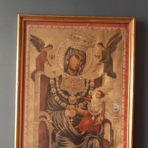 Sacred icon in a golden frame of the Madonna of Montevergine, the print has one part with gilding