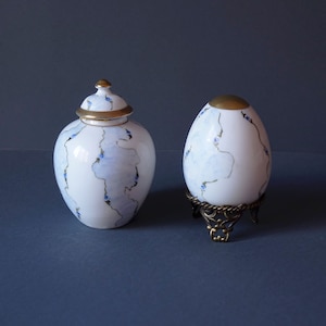 Pair of Limoges porcelain eggs on bronze pedestal hand-decorated with blue roses and pure gold