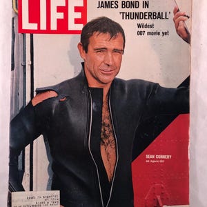 May include: A vintage LIFE magazine cover featuring Sean Connery as James Bond in 'Thunderball'. The cover has a red LIFE logo and text indicating the movie title and date, January 7, 1966. Connery is in a black outfit.