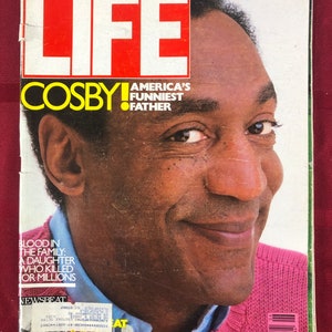 May include: A magazine cover featuring Bill Cosby, with the title "LIFE" and the text "COSBY! America's Funniest Father". The cover also includes the text "Blood in the Family: A Daughter Who Killed or Millions" and "NEWSBEAT".