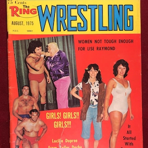 May include: A vintage magazine cover for The Ring Wrestling magazine from August 1975. The cover features a photo of two wrestlers in the ring, and the headline "The Feud That Has Spanned Both Coasts". The cover also features a photo of three women, with the headline "Women Not Tough Enough For Lise Raymond".