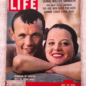 May include: Vintage LIFE magazine cover featuring a smiling man and woman. The cover has the word "LIFE" in large white letters on a red background. Headlines include "GENIAL MASTER SWINDLER" and "JOHANSSON ON VACATION." The date "JULY 20, 1959" is printed at the bottom.