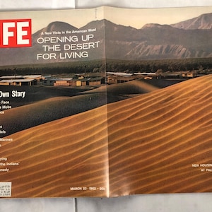 May include: A vintage LIFE magazine cover from March 23, 1962, featuring a photo of sand dunes in the desert. The cover headline reads "Opening Up The Desert For Living".