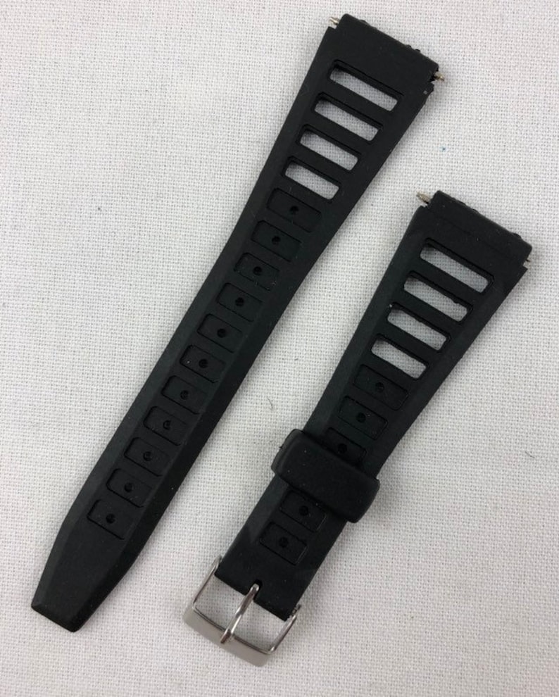 May include: Two black watch bands with silver buckles. The bands have a textured design with small holes.