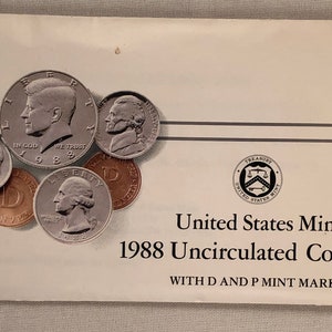 May include: A white envelope with the text "United States Mint 1988 Uncirculated Coin Set WITH D AND P MINT MARKS" and a collection of silver and copper coins featuring the profiles of presidents and other historical figures.