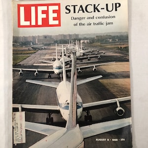 May include: A LIFE magazine cover from August 9, 1968, featuring a photo of a long line of airplanes on a runway. The headline reads "STACK-UP: Danger and confusion of the air traffic jam".