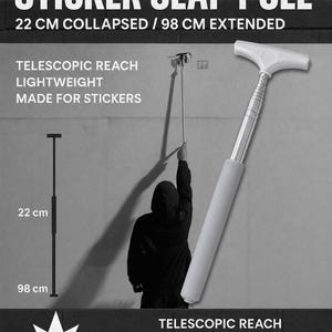 May include: A silver and white telescopic sticker slap pole with a T-shaped head. The text reads STICKER SLAP POLE, 22 CM COLLAPSED / 98 CM EXTENDED, TELESCOPIC REACH, LIGHTWEIGHT, MADE FOR STICKERS, and KOLOR. It measures 8.66 inches to 38.58 inches.